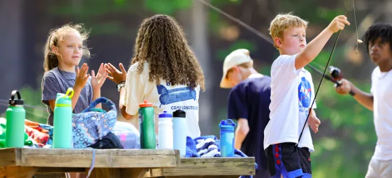 Kids outside with picnic tables and waterbottles