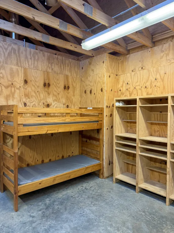 A bunk bed and cubbies in a cabin.
