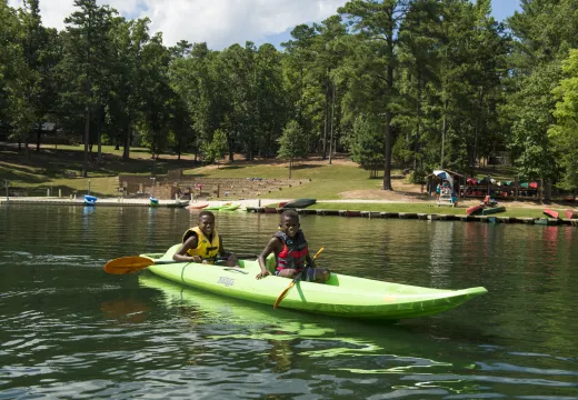 Two boys in a kayak on the lake